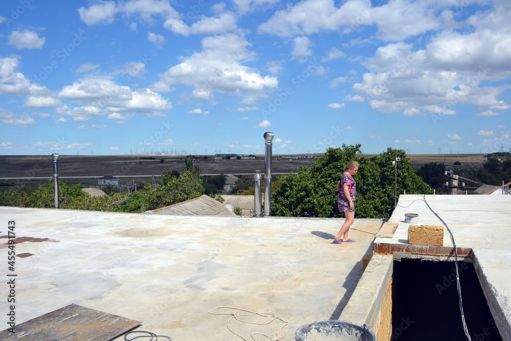 Girl on the flat roof of a house