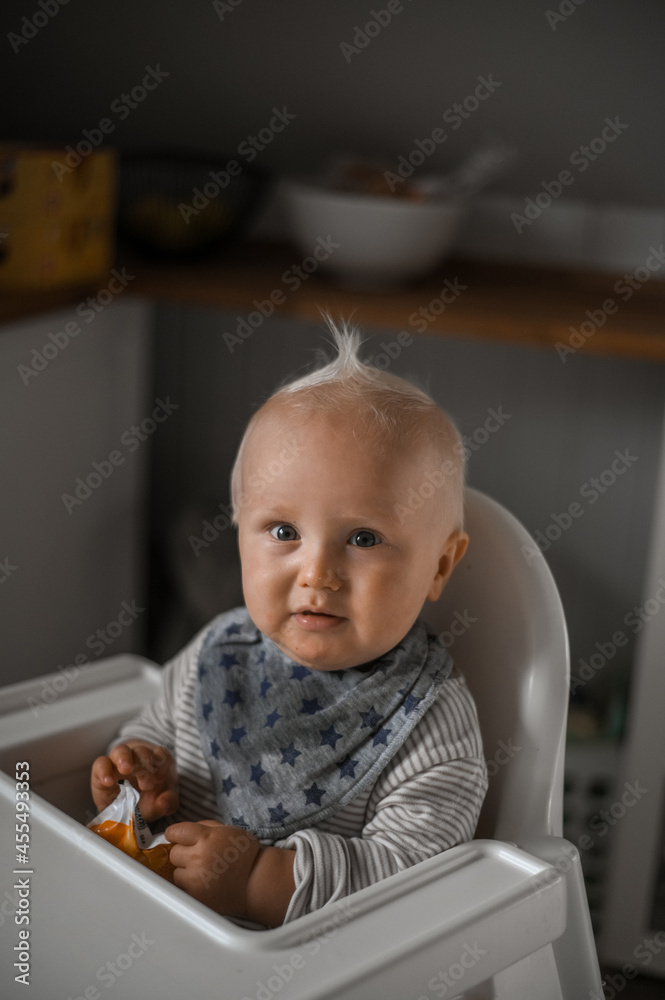 close up  portrait of cute boy smiling eating baby food. Happy childhood