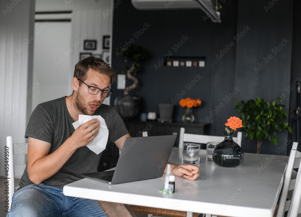 attractive nerdy man with glasses freelance working from home during the covid pandemic or flu attractive nerdy man with glasses freelance working from home during the covid pandemic or flu