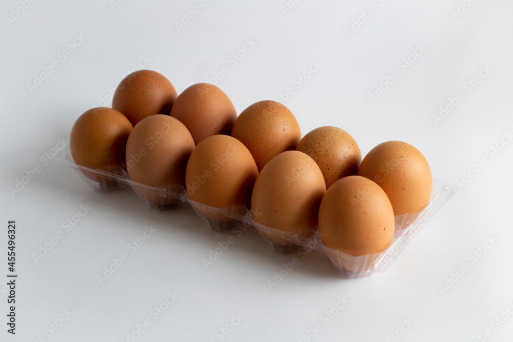 Ten eggs in the egg holder on a white background Ten eggs in the egg holder on a white background