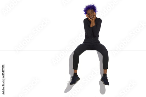 Happy Young Black Woman Is Sitting On A Top
