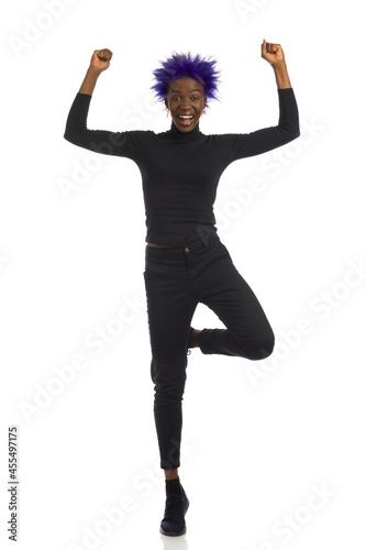 Happy Black Woman Is Standing On One Leg And Cheering.