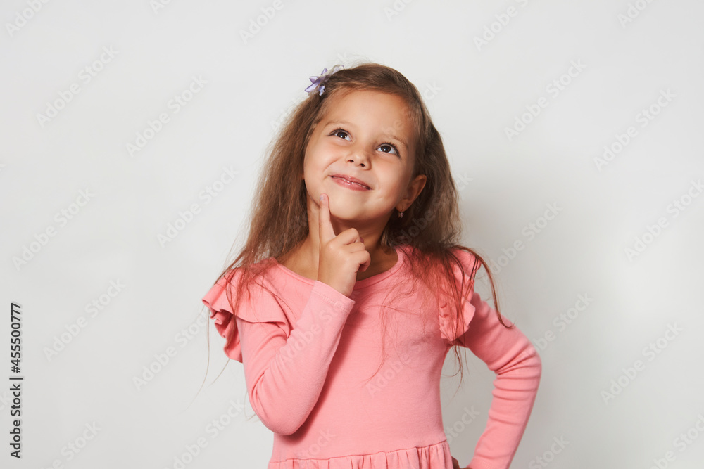 Portrait of cute thoughtful child girl against white background Portrait of cute thoughtful child girl against white background