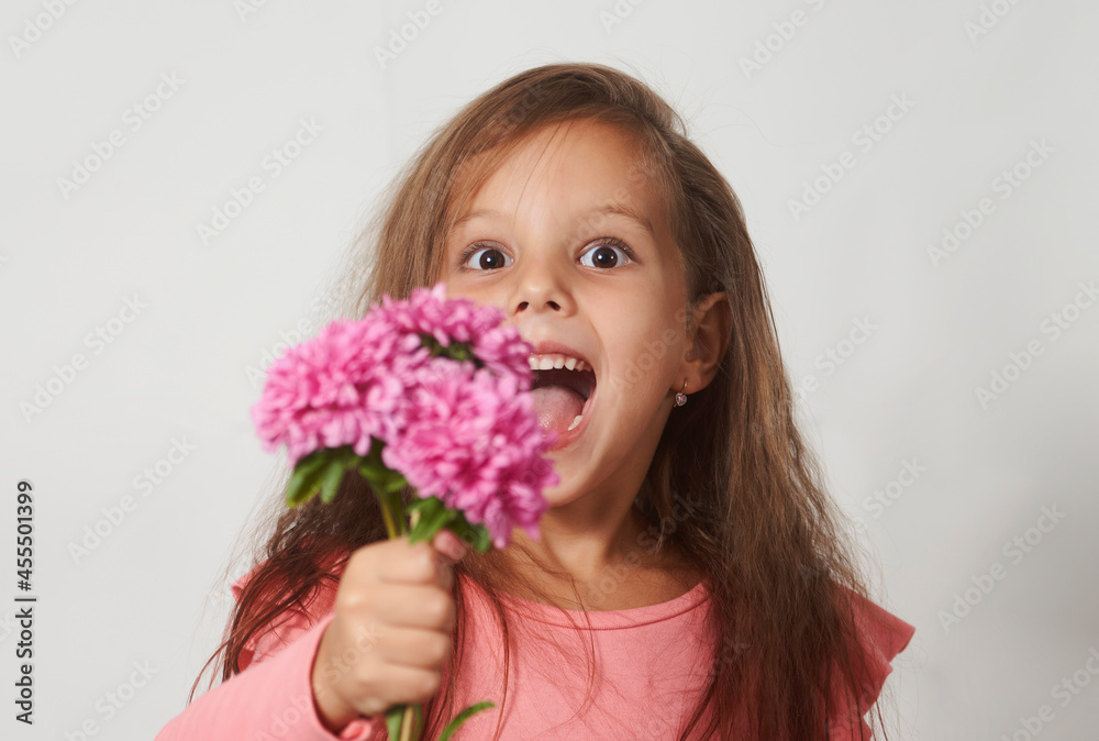 Portrait of a little girl with a flowers bouquet Portrait of a little girl with a flowers bouquet