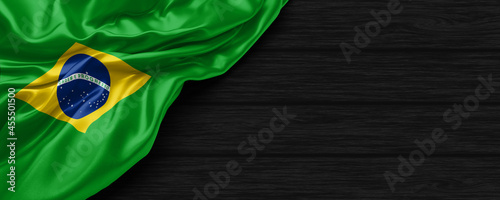 Close Up of Brazil flag on the black wooden background 3D render