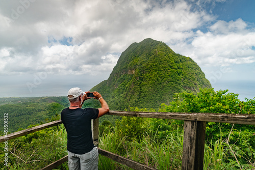Man taking a photo at a scenic lookout along the Tet Paul Nature Trail in St. Lucia