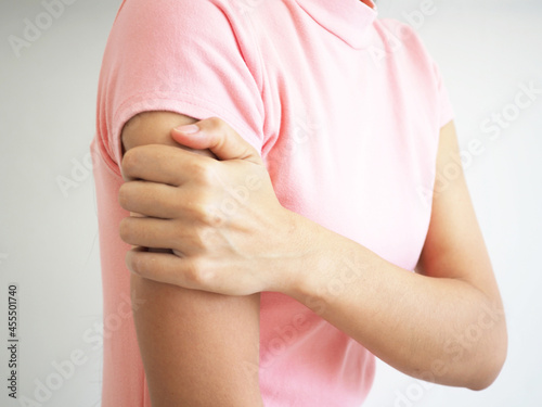 Wallpaper Mural Woman having arm pain on a white background. closeup photo, blurred. Torontodigital.ca