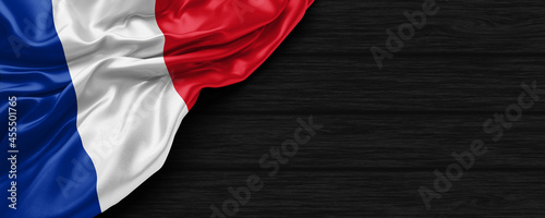 Close Up of France flag on the black wooden background 3D render