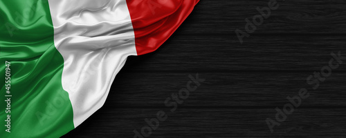 Close Up of Italy flag on the black wooden background 3D render
