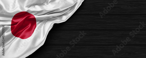 Close Up of Japan flag on the black wooden background 3D render