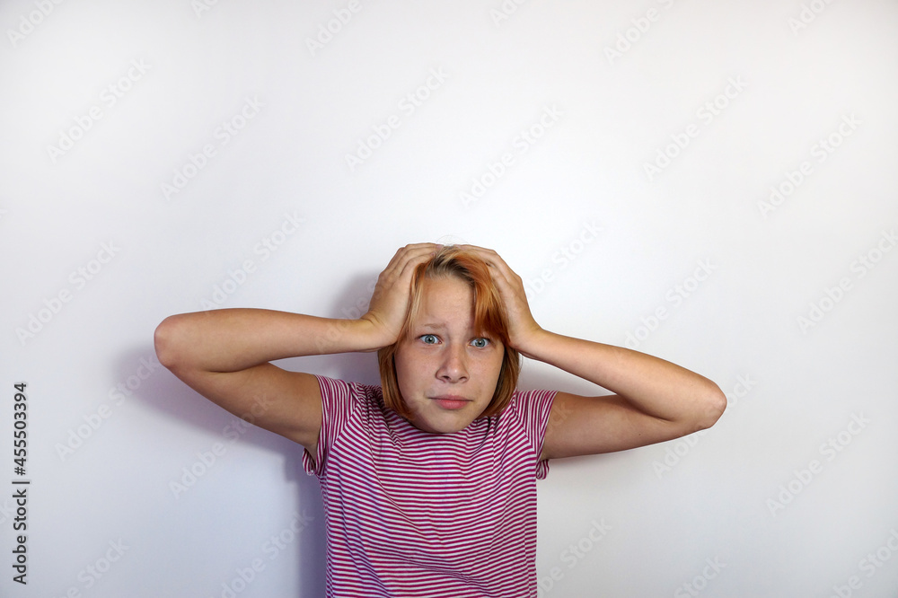 surprised teenage girl grabbed her head with her hands surprised teenage girl grabbed her head with her hands