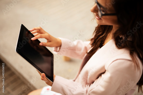 Young businesswoman using tablet outdoors. Beautiful young woman having video call..