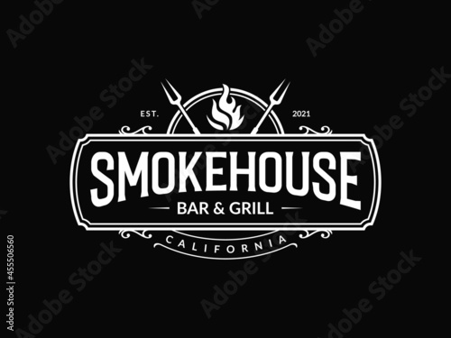 Vintage smokehouse bbq barbecue barbeque bar and grill logo design with fork and fire