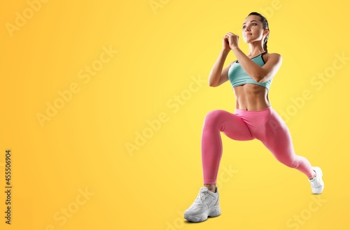 Happy young woman doing exercise at home