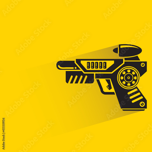 space gun with shadow on yellow background