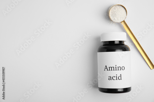 Amino acid powder and jar on white background, top view