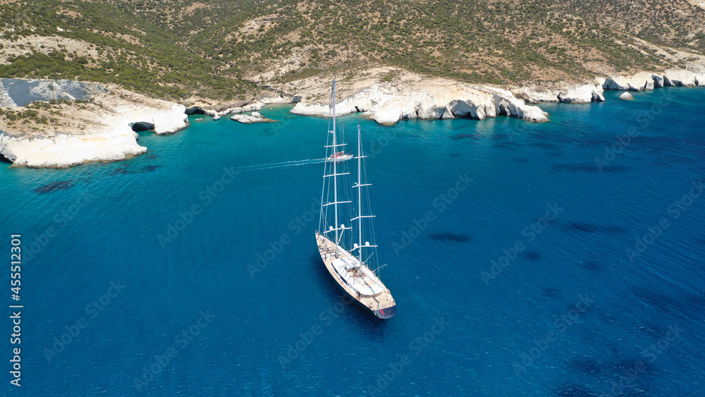 Aerial drone photo of sail boat anchored in Kleftiko - iconic beautiful scenic white volcanic rock formation bay with turquoise crystal clear sea and caves, Sea Meteora of Greece, Milos island