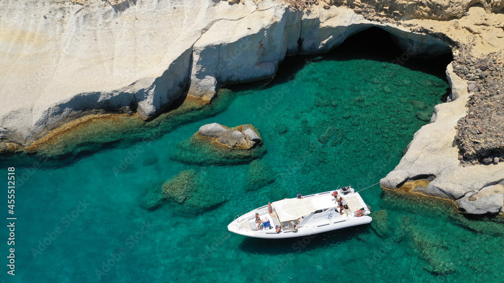 Aerial drone photo of inflatable rib boat anchored in Kleftiko - beautiful scenic white volcanic rock formation bay with turquoise crystal clear sea and caves, Sea Meteora of Greece, Milos island