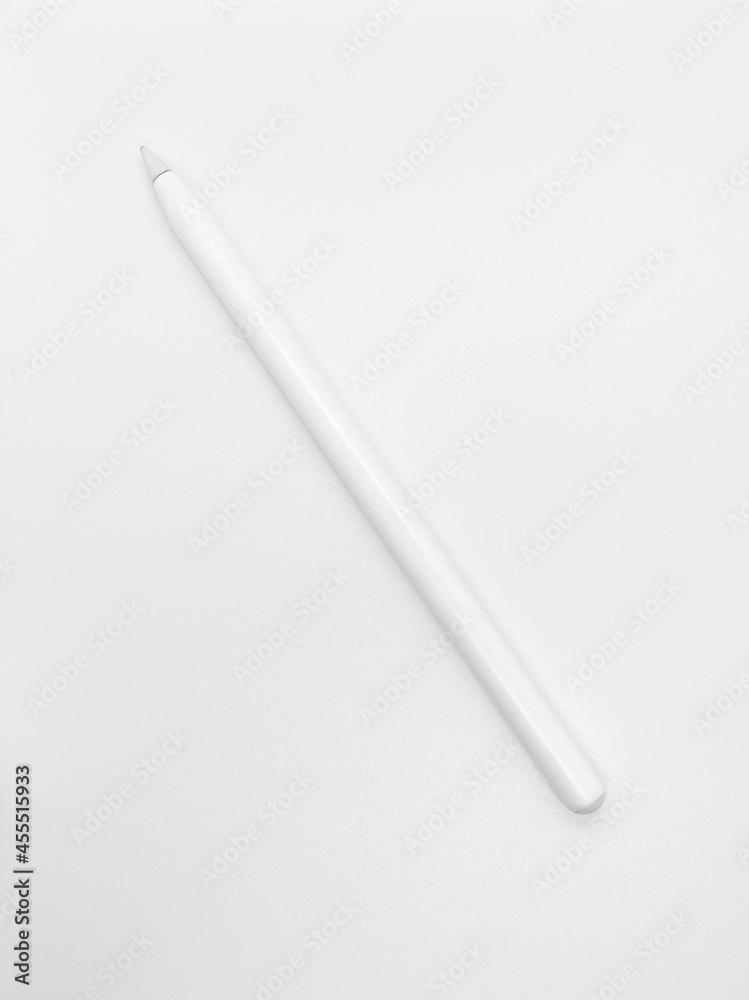 white stylus pen on a white background. a pen to draw or create something on tablet or phone. creating illustration as it's on paper using modern technology. white stylus pen on a white background. a pen to draw or create something on tablet or phone. creating illustration as it's on paper using modern technology.