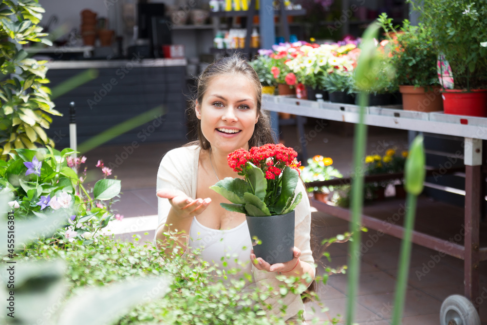 young lovely saleswoman in flower shop