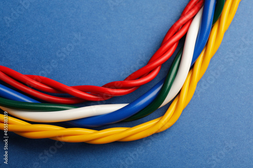 Many electrical cables on blue background, closeup