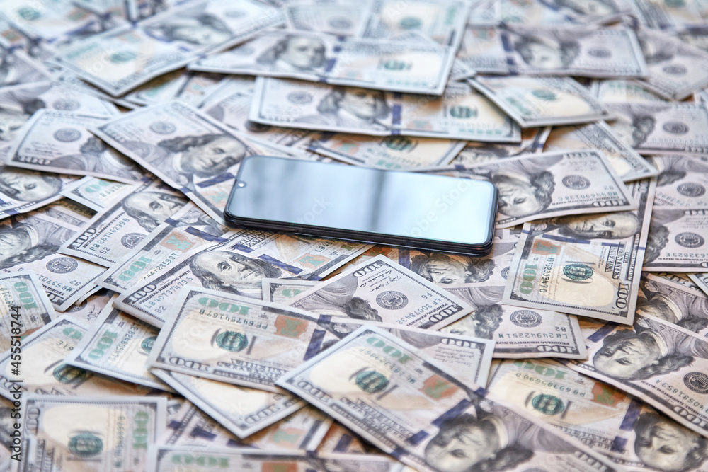 mobile phone on the background of money, the concept of profit mobile phone on the background of money, the concept of profit