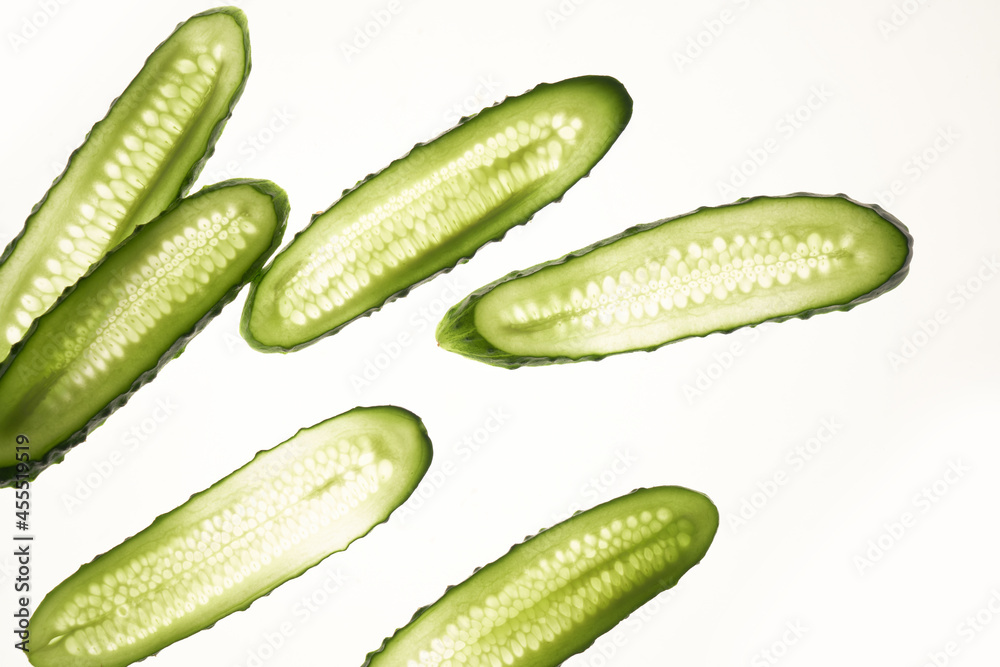 Cucumber green slices pattern isolated on white background. Creative cucumbers wallpaper, food backdrop design Cucumber green slices pattern isolated on white background. Creative cucumbers wallpaper, food backdrop design