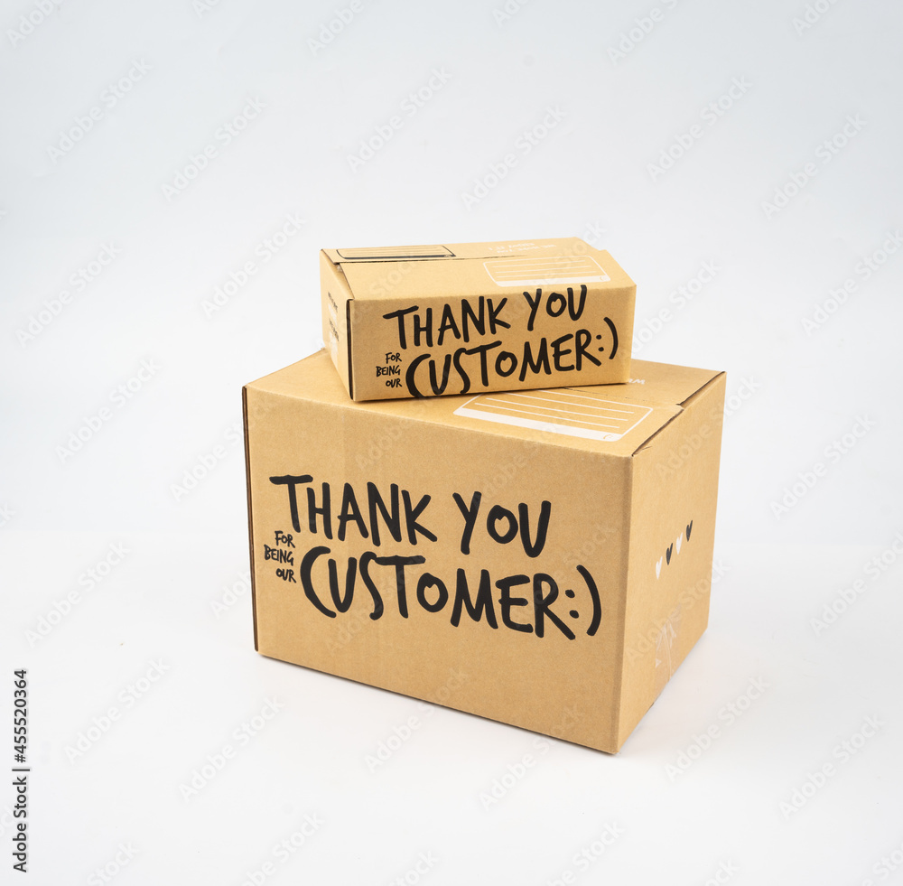 Two closed cardboard boxes taped up, and there is a Thank you for being our customer beside the parcel box for delivery and shopping online concept design isolated on white background. Two closed cardboard boxes taped up, and there is a Thank you for being our customer beside the parcel box for delivery and shopping online concept design isolated on white background.