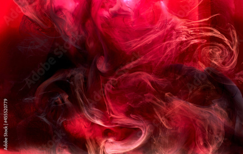 Red black pigment swirling ink abstract background  liquid smoke paint underwater