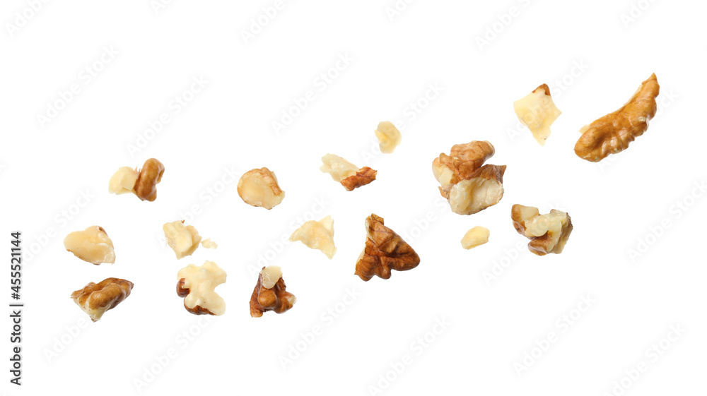 Pieces of walnut falling on white background Pieces of walnut falling on white background