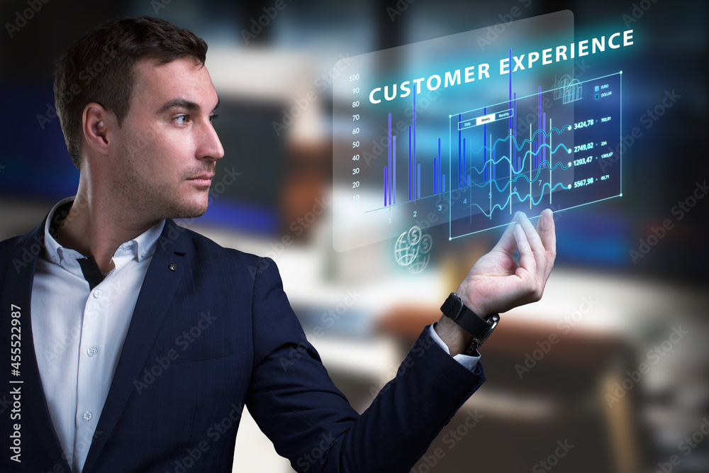 Business, Technology, Internet and network concept. Young businessman working on a virtual screen of the future and sees the inscription: Customer experience Business, Technology, Internet and network concept. Young businessman working on a virtual screen of the future and sees the inscription: Customer experience