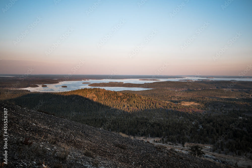View from the mountain to the natural landscape with a lake and blue sky
