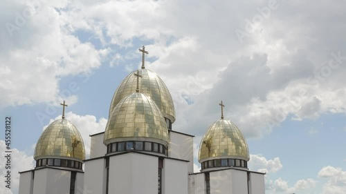 Dome of the church. Aerial view. Traditional old famous church in Lviv, Ukraine city. Cloudy blue sky background. Rizdva Presviatoyi Bohorodytsi Church. 4K UHD drone footage. Copy-space photo