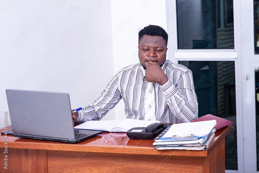 Fototapeta premium Pensive adult businessman working in the office.