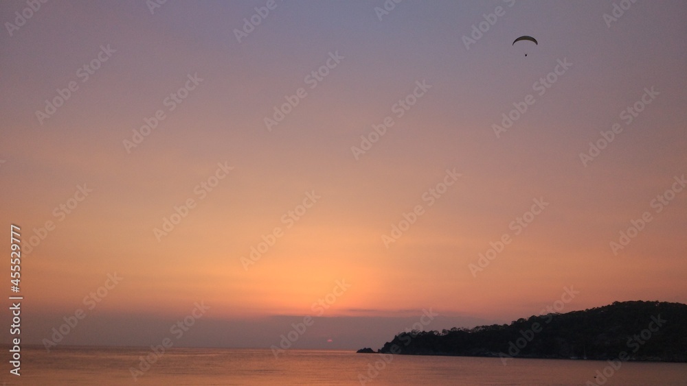 Paraglider on the background of sunset