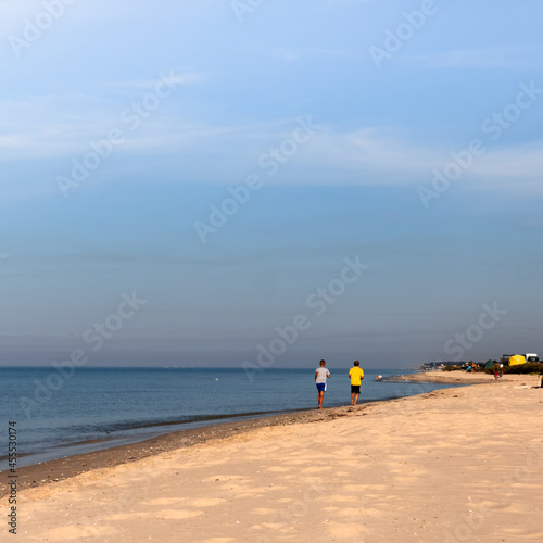 Two men take a morning jog along the Black Sea coast.