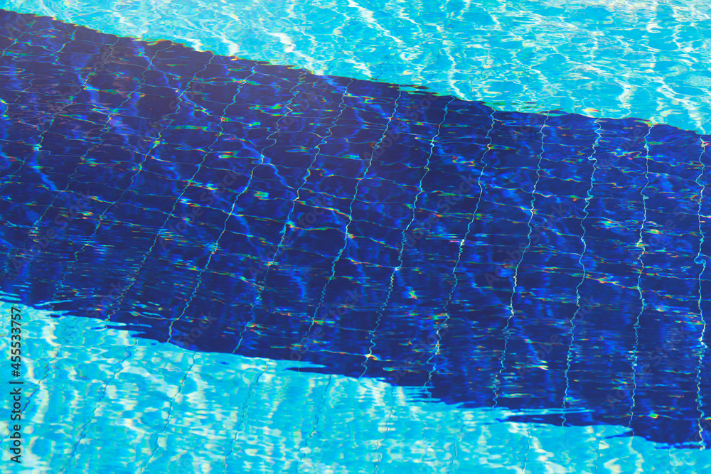 Water abstract background, Swimming pool rippled. Hotel swimming pool with sunny reflections