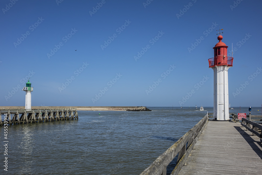 Entrance of the Trouville port. Red Lighthouse tower on the seacoast. Trouville, Calvados department, Normandy, France.