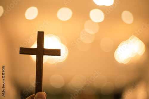 Christian cross with blurred bokeh background light at church.