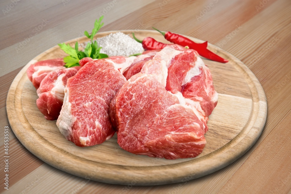 Raw red fresh steak of beef on a board with seasonings