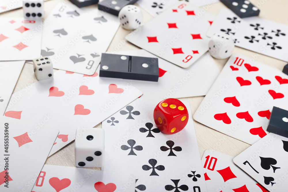 Dice, dominoes and playing cards for board games on table close up. Dice, dominoes and playing cards for board games on table close up.