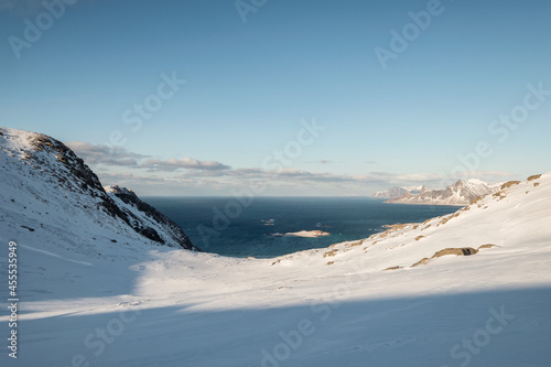 Snow covered mountain range and arctic ocean on winter in sunny day