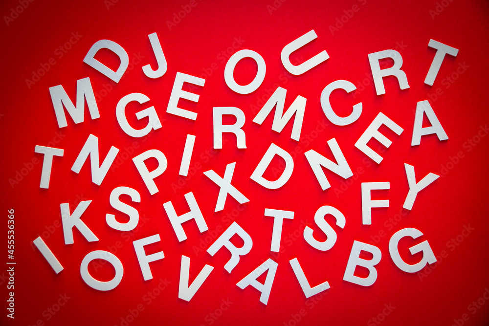 Mixed letters pile top view photo. Red background Mixed letters pile top view photo. Red background
