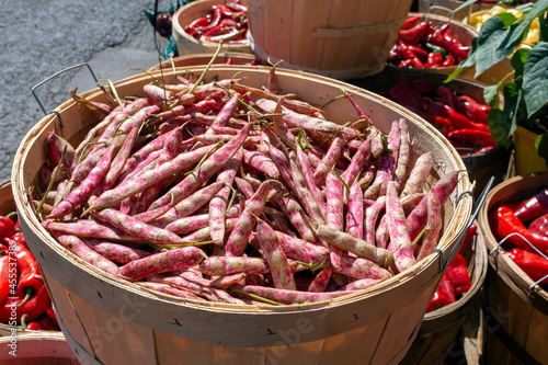 Pink and white Borlotti or cranberry beans are seen with red peppers at the market. photo