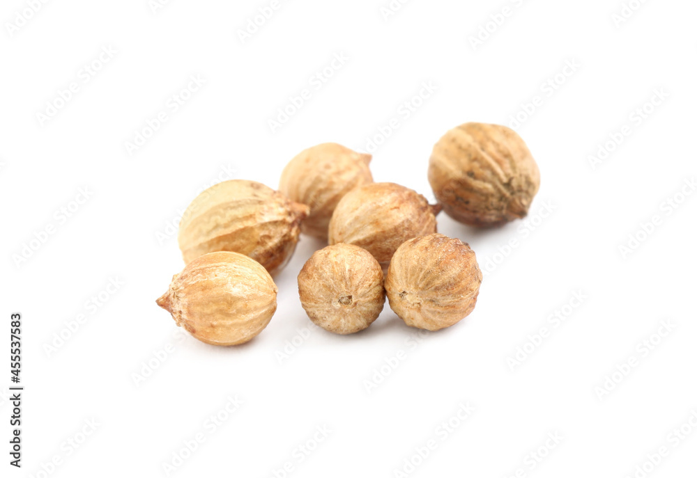Scattered dried coriander seeds on white background, closeup
