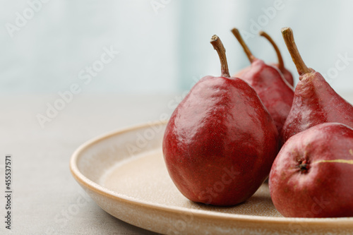 Fresh red pears on light background