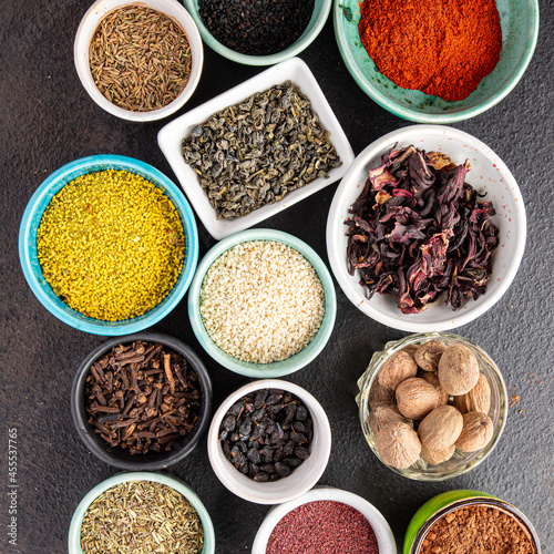 spices and herbs for cooking. Sumac, pepper, paprika, rosemary, khmelisuneli, cloves and more fresh portion ready to eat meal snack on the table copy space food background rustic. top view