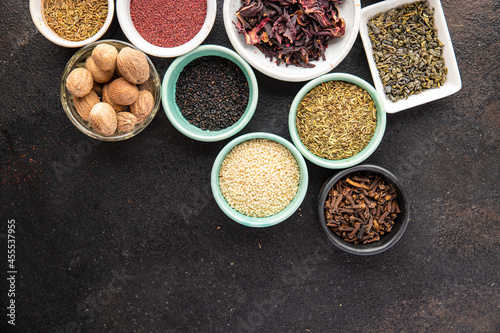 spices and herbs for cooking. Sumac, pepper, paprika, rosemary, khmelisuneli, cloves and more fresh portion ready to eat meal snack on the table copy space food background rustic. top view photo