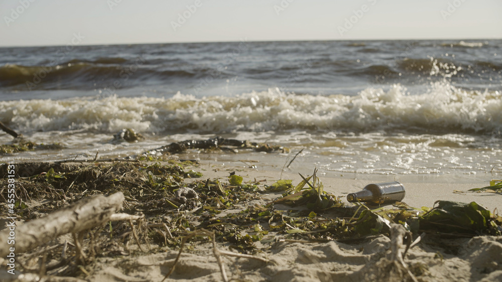 Fototapeta premium Garbage washed by sea water on beach, environmental contamination problem nature