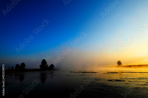 Morning Sunrise with Trees and River Blue Sky and Glowing Mist © Lane Erickson